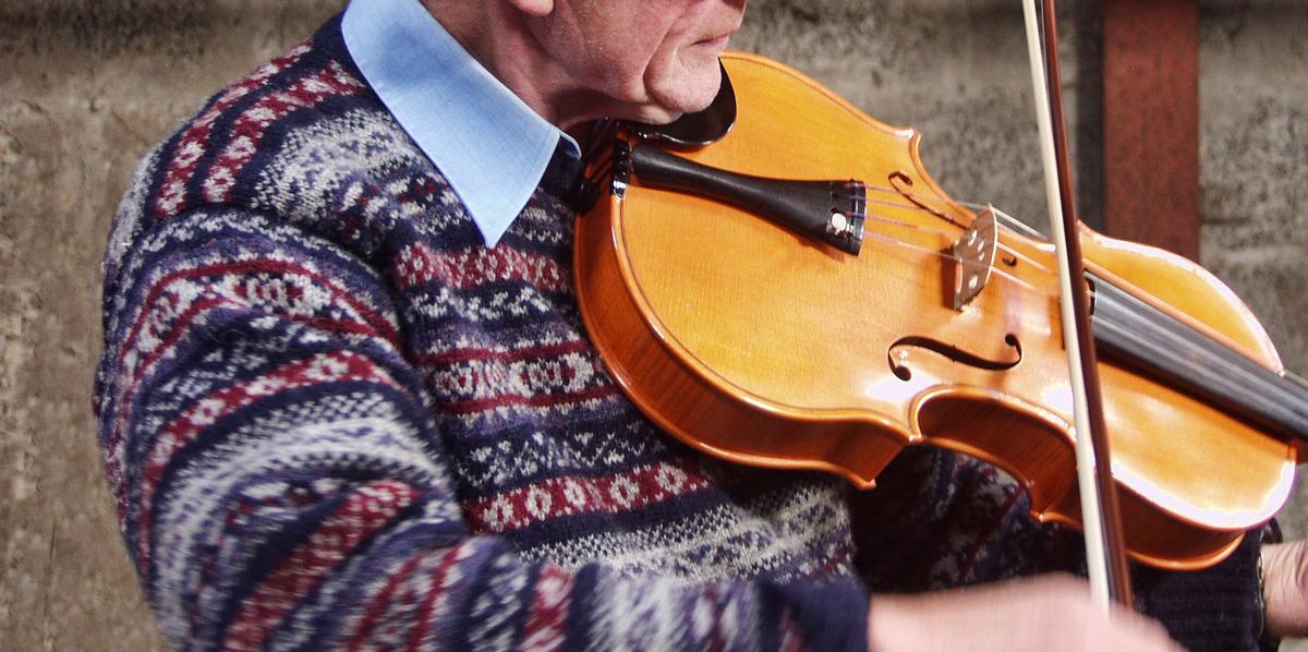 fiddle vs violin older man plays fiddle