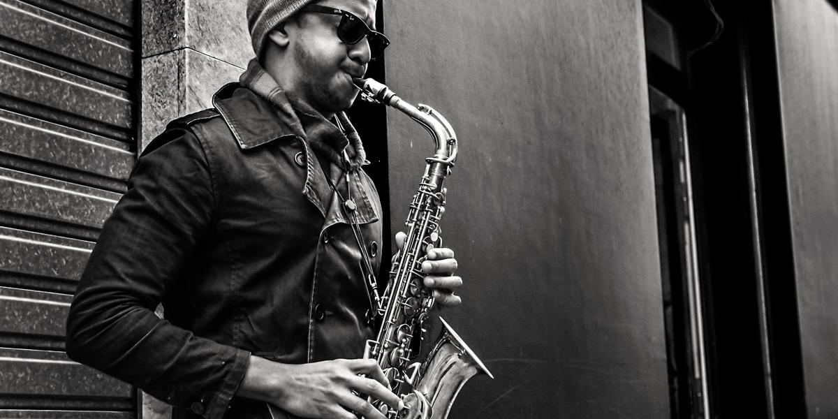 black and white picture of man forming saxophone embouchure