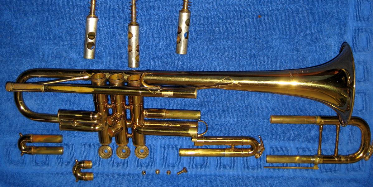 Trumpet parts spread out on a towel for cleaning