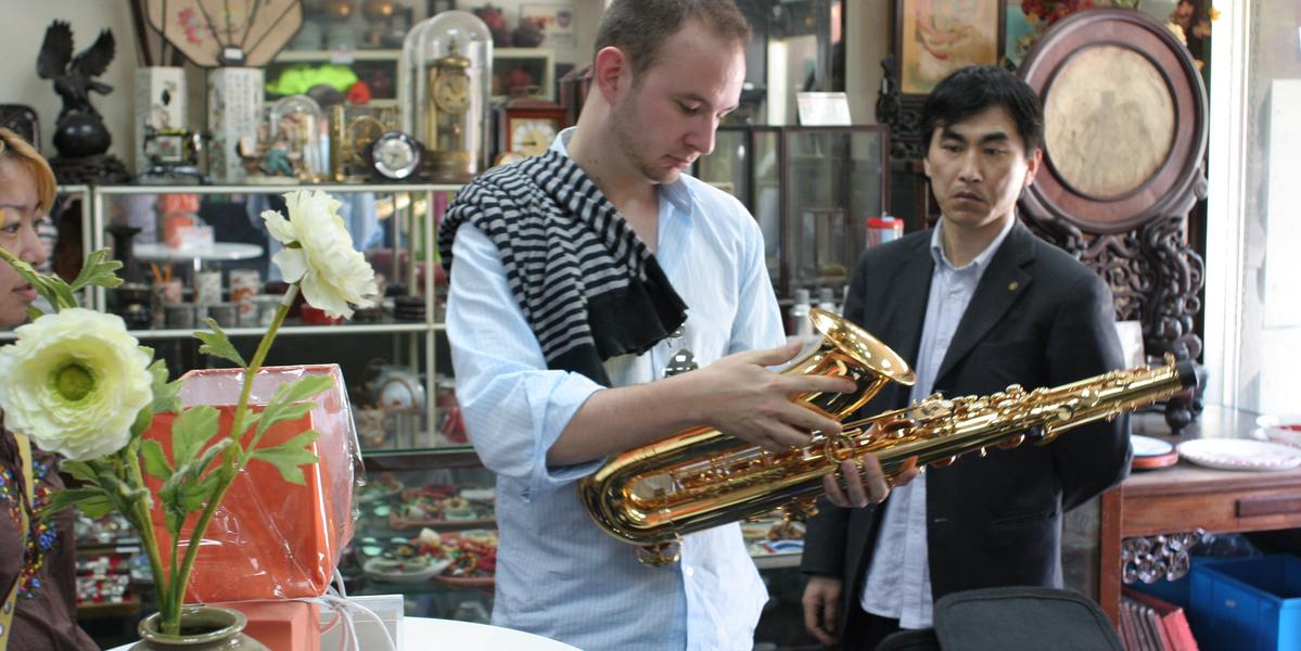 Comparing used saxophones at a store